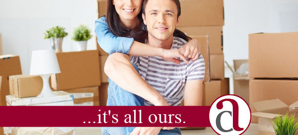 young couple with boxes in new build home
